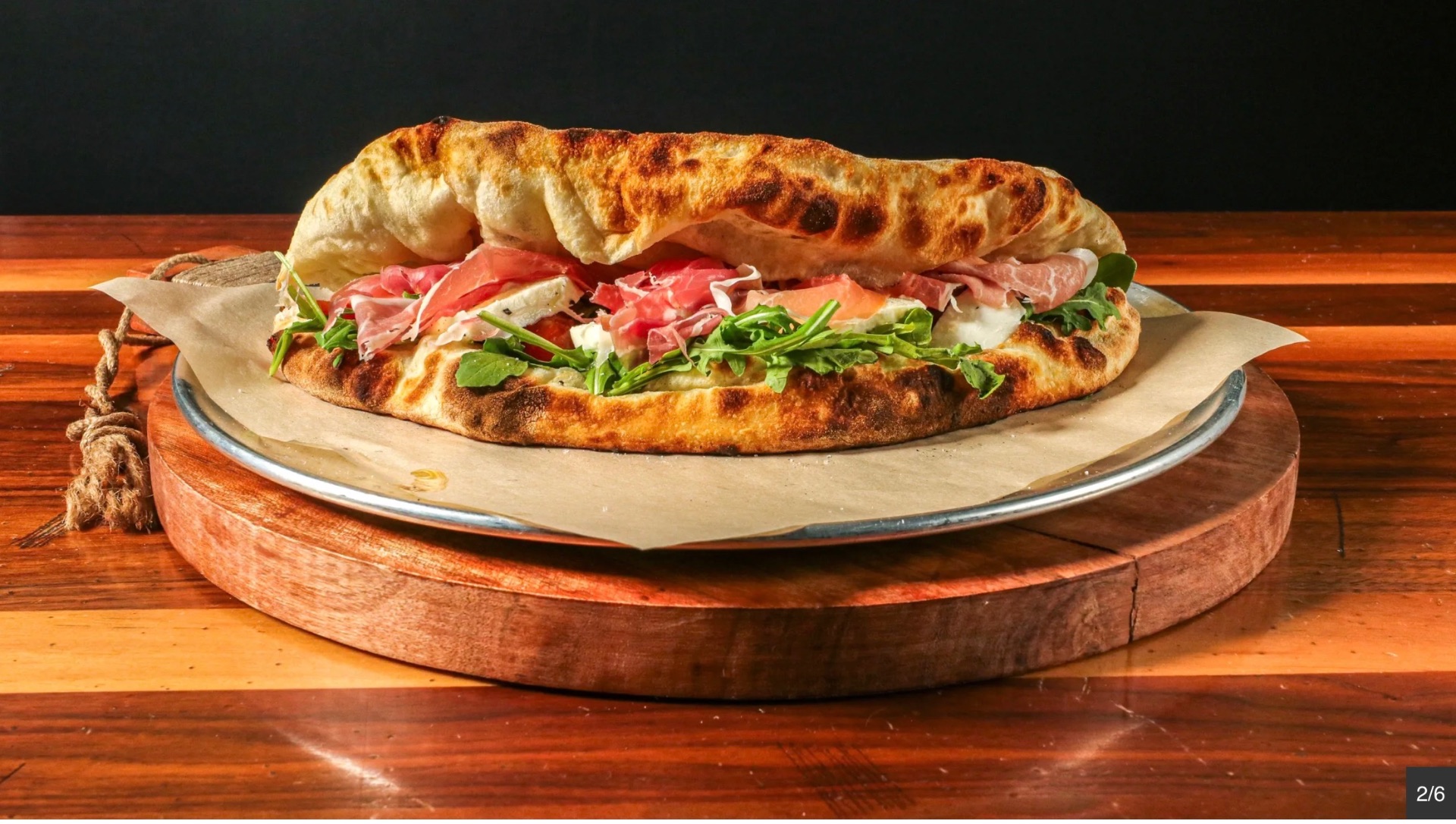 Stuffed calzone with prosciutto and arugula