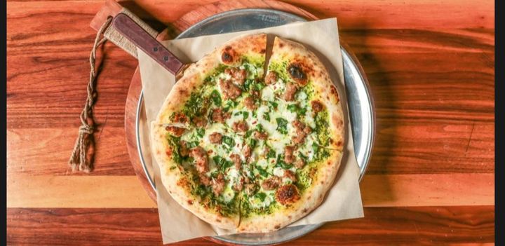 Pesto and sausage pizza